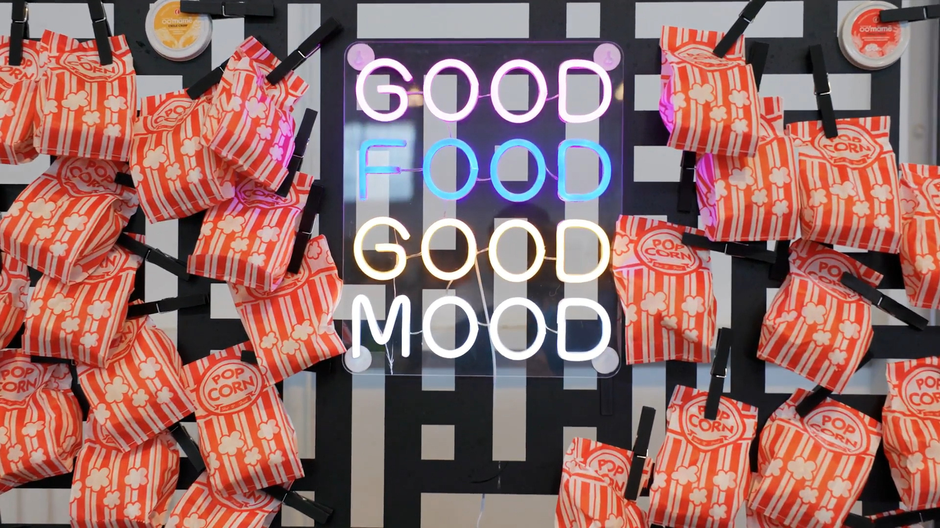 Sign displaying the words good food good mood surrounded by popcorn bags