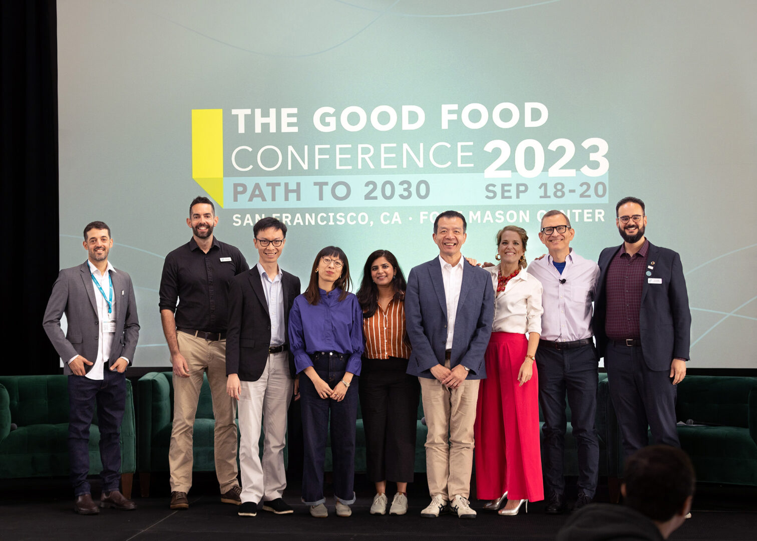 Members of the gfi team and partners from around the world gather on the main stage at the 2023 good food conference