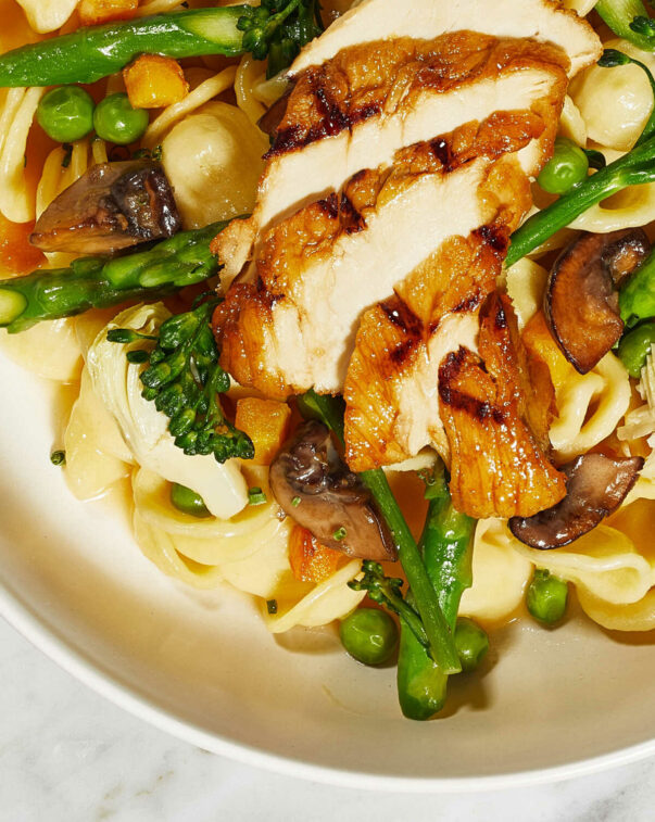 A dish featuring cultivated chicken, pasta, and asparagus.  photo courtesy of good meat.