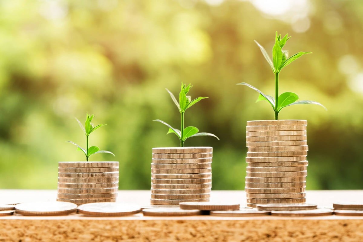 Stacks of coins with plants growing out of them_impact investing_esg