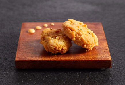 Two chicken bites on wood slate